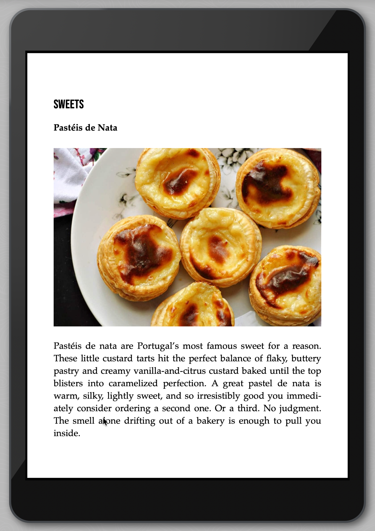 Plate of Pastéis de Nata with descriptive text on a tablet screen.
